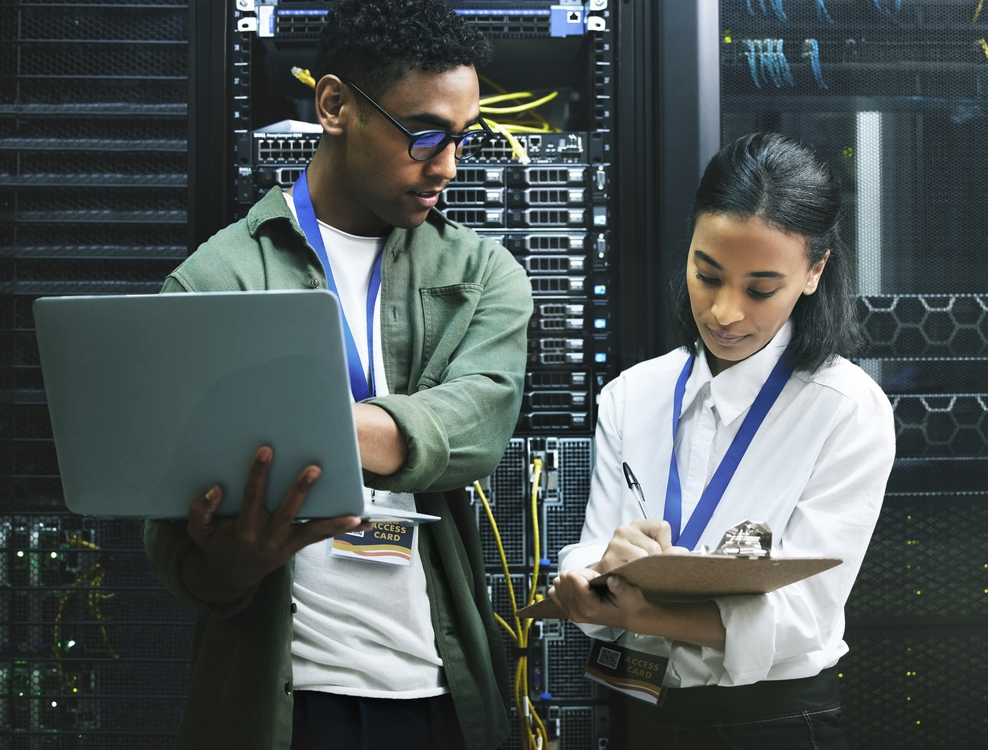 Shot of two technicians working together in a server room